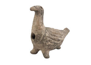 A Western Asiatic-style pottery bird, resting on three feet, with carved feathers, elongated head and eye holes, 13cm. diam. x 11.5cm. high
		Lord Anthony Jac