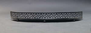 
	
		A black painted iron fender, 19th Century, with pierced Greek key pattern, on ball feet,...