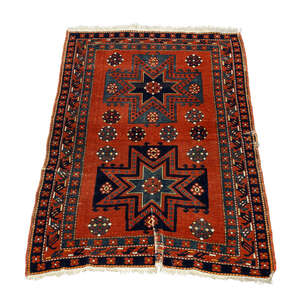 
	
		A Shirvan rug, early 20th century, with two star medallions in a deep red field, enclosed...