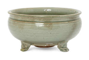 
	
		A Chinese Longquan celadon tripod censer, Ming dynasty, the everted rim above a band of...