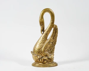 A brass doorstop in the form of a swan, 20th century, modelled sitting amongst reeds, 37.5cm high