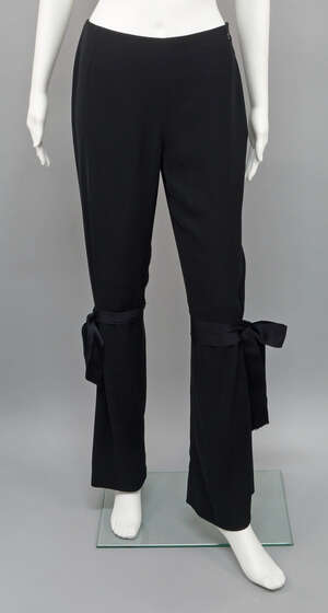 
	
		Chanel: a pair of black fine wool trousers, with ribbon and bow details at the knee,...