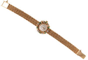 
	
		A Lady's diamond and emerald wristwatch, the circular dial with applied baton indicators,...