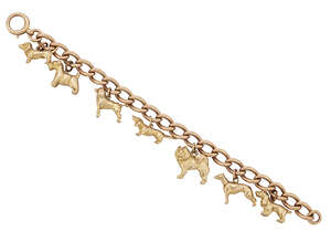 
	
		A charm bracelet, the 9ct gold curb link bracelet suspending seven charms each depicting...