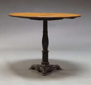 
	
		An oak and cast iron side table, early 20th Century, the circular oak top on cast iron...