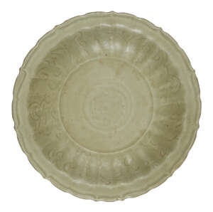 
	
		A Chinese Longquan celadon dish, Ming dynasty, with a foliate rim and incised floral...