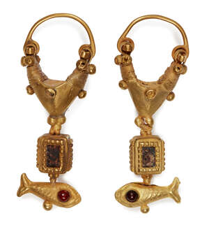 A pair of garnet-set gold earrings with fish, 2nd century B.C. -1st century A.D., the suspension hoops, 4cm high, weight 7.2gr. (2)
		Provenance: Acquired 200