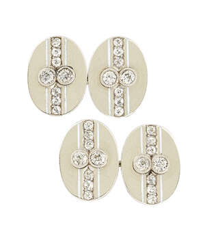 A pair of diamond cufflinks, each oval panel with old brilliant-cut diamond two stone centre and single-cut diamond line detail, to figure-of-eight link connec