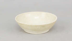 
	
		A Chinese white stoneware dish or box base, Yuan Dynasty, with a pale cream glaze over a...