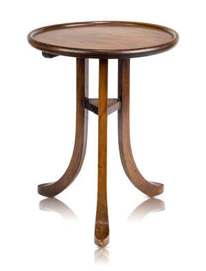 Liberty & Co, a 'Wylye' mahogany occasional table
		c.1904
		Circular top, raised on three splayed feet united by a triangular under-tier
		46 cm hi