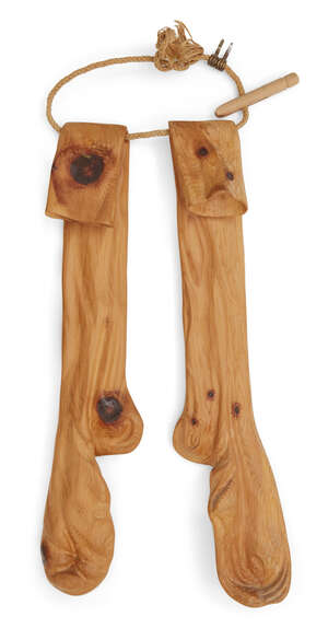 
	
		Livio De Marchi (Italian b.1943), a pine carving of a pair of stockings,
		c.1990, each...