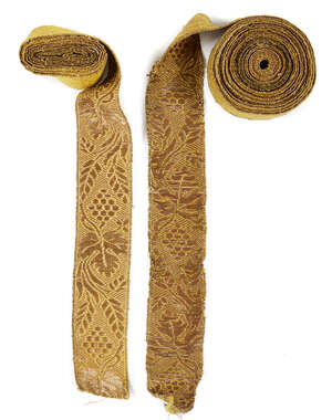
	
		A length of gold covered silk embroidered trim, late 19th century, finely decorated with...