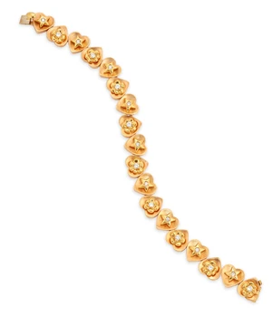 Stefan Hafner. A diamond set bracelet, designed as a series of satin-finish heart shaped panels, alternately applied with brilliant-cut diamond set floral or s
