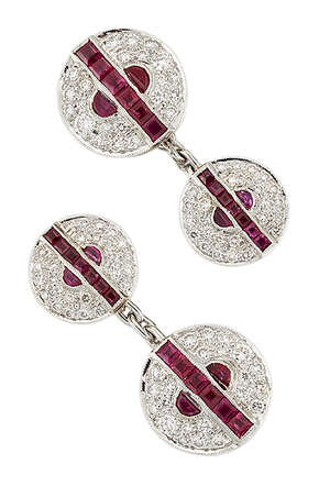 A pair of ruby and diamond cufflinks, composed of brilliant-cut diamond graduated circular panels with central calibré-cut ruby line and half-moon ruby two st