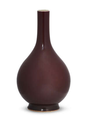 
	
		A Chinese monochrome porcelain bottle vase, 18th century, with allover copper-red glaze,...