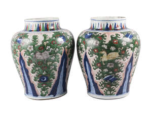 A large pair of Chinese wucai porcelain vases, Transitional period, each painted in enamels with four horses on a dense ground decorated with prunus blossom di