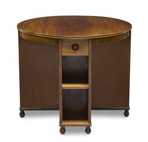 
	
		Heal & Son, a walnut 'Book' table
		Early 20th Century, 
		The circular top over two...