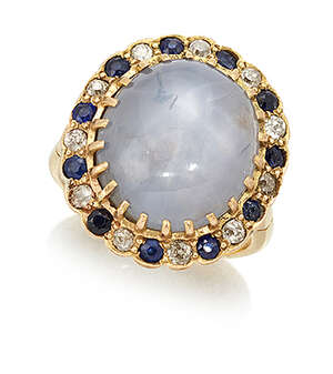 
	
		A star sapphire and diamond cluster ring, the central cabochon star sapphire in claw-set...
