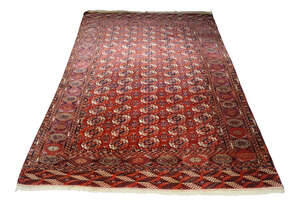 
	
		A Bukhara carpet, early to mid 20th century, with five rows of elephant foot guls, the...