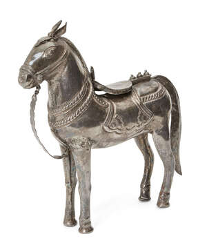 
	
		A silver horse, India, circa 1900, standing, the bridle and saddle formed of separate...