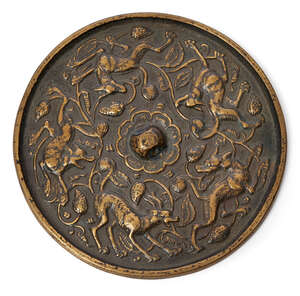 
	
		A Chinese copper alloy 'lion and grape' mirror, 18th century, cast with raised central...