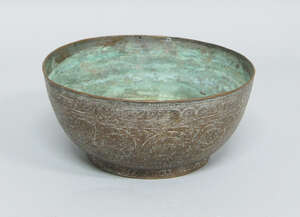 
	
		A tinned copper bowl, Iran, 19th century, engraved with bands of calligraphy and trailing...