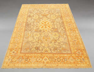 
	
		A large Oushak pattern woolen carpet, mid-20th century, with floral design to central...