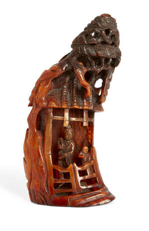  A Chinese buffalo horn carving, 19th century, carved as Guanyin standing inside a pavilion...