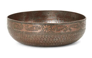 An engraved tinned copper magic bowl,North India, 19th century,
On plain base, densely inscribed...