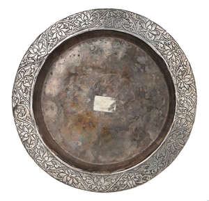 
	
		An early Mughal chased and repousse work silver dish, India, late 16th-early 17th...
