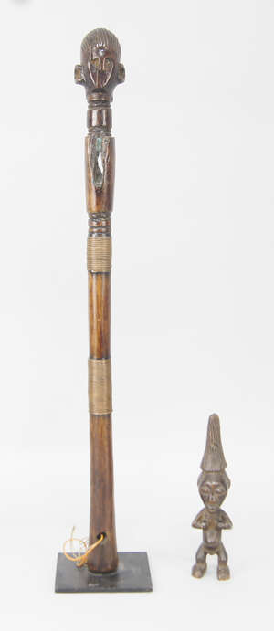 
	
		A tribal hardwood staff head, with a carved head form finial, the cylindrical body with...