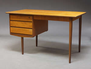 
	
		A Danish teak desk, c.1960, the rectangular top above kneehole, and three drawers, on...