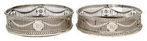 
	
		A pair of pierced silver wine coasters, London, c.1772, John Lambe, with beaded edges and...