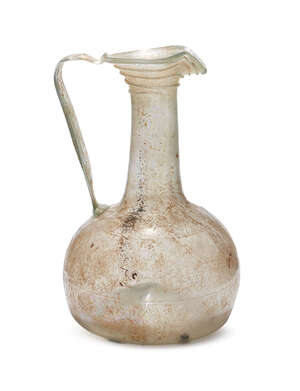 
	
		A large blown glass ewer with Kufic inscription, Iran, the globular bottom with everted...