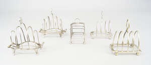 
	
		A pair of silver four division toast racks, London c.1929, William Comyns & Sons Ltd...
