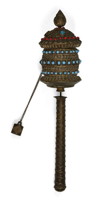
	
		A Tibetan brass prayer wheel, early 20th century, set with turquoise and red glass beads,...