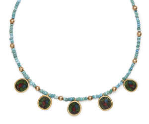 
	
		An ancient coloured glass necklace with Egyptians heads in modern gold pendant mounts,...