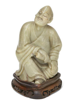 
	
		A Chinese soapstone carving of Luohan, 19th century, carved in a relaxed seated position...