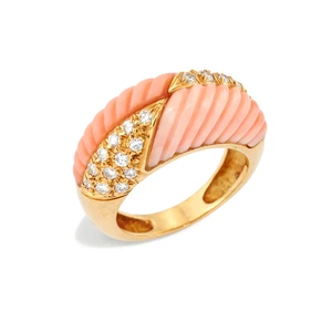 A French coral and diamond ring, the bombé head with quartered carved coral and pavé brilliant-cut diamond set panels, to plain hoop, French mark and maker's