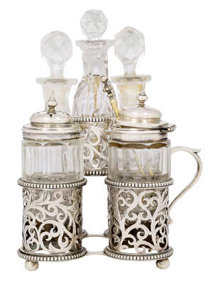 
	
		A Victorian silver cinquefoil cruet set, London, c.1861, George Fox, the five cut glass...