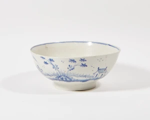 An English porcelain blue and white punch bowl, possibly Liverpool or Lowestoft, c.1760s, the exterior painted in underglaze blue with a continuous Chinoiserie