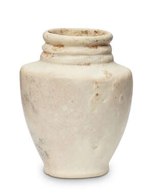 A Bactrian marble vase, 3rd millenium B.C., with foot ring, high shoulder, three rings to neck, 7.3cm. high
		Provenance: Property of a Gentleman, acquired in