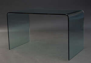 
	
		A large contemporary glass desk  
		c. 2000 
		Formed from one piece of curved glass,...