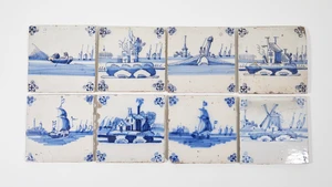 Eight Dutch Delftware blue and white tiles, 18th - 19th centuries, each with foliate head corners, depicting landscape scenes including two with masted ships, 