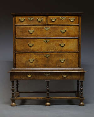 
	
		A George I and later walnut chest on stand, the moulded cornice above two short and three...