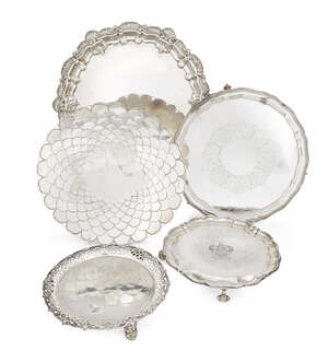 Five assorted silver and silver plate salvers, the largest decorated with shell and scroll border and raised on three bracket feet, Birmingham, c.1902, William
