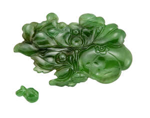 
	
		An unmounted carved jadeite jade plaque, of flowerhead and foliage design, weighing...