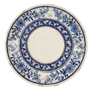 
	
		A Qajar blue and white underglaze painted dish, Iran, late 19th century, of shallow form,...