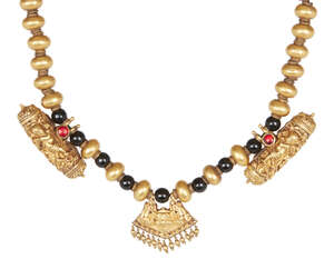 
	
		A South Indian gold and onyx necklace, composed of a series of gold beads of compressed...