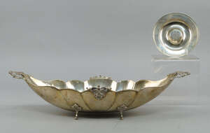 
	
		A Continental 800 fineness silver planished boat shape bowl, with lobed body and leaf...